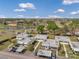 Aerial view of a residential community featuring well-maintained homes, a pond, and convenient parking at 1801 Bedford Ter # 221, Sun City Center, FL 33573