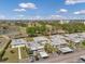 Aerial view of a community featuring well-kept homes, parking areas, and a lake with a fountain at 1801 Bedford Ter # 221, Sun City Center, FL 33573