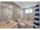 Bathroom offers a shower and tub combination, white tile and blue and white stripped shower curtain at 1801 Bedford Ter # 221, Sun City Center, FL 33573