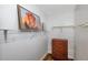 Closet boasting ample shelf space with a wooden dresser beneath a picture, maximizing storage solutions at 1801 Bedford Ter # 221, Sun City Center, FL 33573