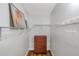 Spacious closet with ample shelving and a wooden dresser, complemented by a wall of hooks at 1801 Bedford Ter # 221, Sun City Center, FL 33573