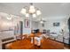 Open floor plan features dining area with wooden table and chairs, flowing into the living room and kitchen at 1801 Bedford Ter # 221, Sun City Center, FL 33573