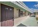 Street-side view of condo showcasing charming exterior, light-colored stucco walls, and welcoming front door at 1801 Bedford Ter # 221, Sun City Center, FL 33573