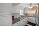 Well-lit kitchen featuring granite countertops, white cabinets, tile backsplash and stainless steel appliances at 1801 Bedford Ter # 221, Sun City Center, FL 33573