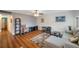 Cozy living room with hardwood floors, comfortable sectional sofa, ceiling fan, and decorative rug at 1801 Bedford Ter # 221, Sun City Center, FL 33573