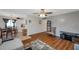 Open concept living space with hardwood flooring, view of dining table and kitchen at 1801 Bedford Ter # 221, Sun City Center, FL 33573
