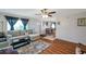 Open-concept living space with a comfortable sectional sofa, a view of dining area, and hardwood flooring at 1801 Bedford Ter # 221, Sun City Center, FL 33573