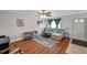 Inviting living room featuring a comfortable sofa, a window with curtains, and hardwood floors at 1801 Bedford Ter # 221, Sun City Center, FL 33573