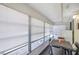 Screened patio with many windows, complete with a table and chairs at 1801 Bedford Ter # 221, Sun City Center, FL 33573