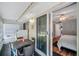 Enclosed patio leading to a bedroom, featuring a ceiling fan and sliding glass doors at 1801 Bedford Ter # 221, Sun City Center, FL 33573