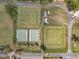 Birds-eye shot of a recreational area, complete with lawn bowling, tennis courts, and well-manicured gardens at 1801 Bedford Ter # 221, Sun City Center, FL 33573