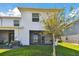 Exterior of home with well-maintained lawn and covered patio at 1869 Hovenweep Rd, Wesley Chapel, FL 33543