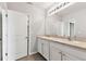 Bathroom featuring a double vanity, neutral countertops, and ample storage space with white cabinetry at 1869 Hovenweep Rd, Wesley Chapel, FL 33543