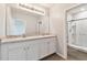 Bright bathroom with double vanity, white cabinets, and a glass-enclosed shower at 1869 Hovenweep Rd, Wesley Chapel, FL 33543