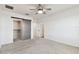Bright bedroom featuring a ceiling fan, grey barn door, and a neutral color palette at 1869 Hovenweep Rd, Wesley Chapel, FL 33543