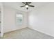 Cozy bedroom with a ceiling fan, carpet, and a window at 1869 Hovenweep Rd, Wesley Chapel, FL 33543