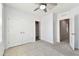 This bedroom features a ceiling fan, closet, and neutral carpet at 1869 Hovenweep Rd, Wesley Chapel, FL 33543