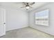 Cozy bedroom with neutral colors, carpet, ceiling fan, and natural light at 1869 Hovenweep Rd, Wesley Chapel, FL 33543