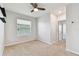 Bright, carpeted bedroom with a ceiling fan and natural light from the window at 1869 Hovenweep Rd, Wesley Chapel, FL 33543