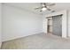 Bedroom featuring a barn door closet and neutral carpet at 1869 Hovenweep Rd, Wesley Chapel, FL 33543