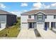 This home boasts an attached garage, manicured lawn, and sidewalk at 1869 Hovenweep Rd, Wesley Chapel, FL 33543