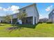 Exterior rear of home showing screened in patio and lawn at 1869 Hovenweep Rd, Wesley Chapel, FL 33543