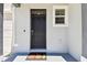 Front door detail with black door, digital doorbell, and autumn themed doormat at 1869 Hovenweep Rd, Wesley Chapel, FL 33543