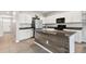 Bright kitchen with white cabinets, black appliances, granite countertops, and tile flooring at 1869 Hovenweep Rd, Wesley Chapel, FL 33543