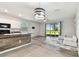 An open living space with hardwood floors and sliding door access to the outside at 1869 Hovenweep Rd, Wesley Chapel, FL 33543