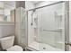 Modern bathroom shower with glass door, built-in shelving, and sleek fixtures at 1869 Hovenweep Rd, Wesley Chapel, FL 33543