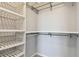 Spacious walk-in closet featuring white shelving and a clothing rod for optimal storage and organization at 1869 Hovenweep Rd, Wesley Chapel, FL 33543