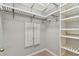 Organized walk-in closet with adjustable shelving and hanging rods, maximizing storage space at 1869 Hovenweep Rd, Wesley Chapel, FL 33543