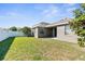 A view of the backyard with a green lawn and a white privacy fence at 200 Fairmont Dr, Spring Hill, FL 34609
