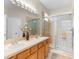 Bright bathroom with double sinks, tiled shower with glass doors, and modern fixtures at 200 Fairmont Dr, Spring Hill, FL 34609