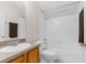 Bright bathroom features a shower-tub combo and a wood vanity at 200 Fairmont Dr, Spring Hill, FL 34609