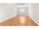 Bright bedroom features hardwood floors, a ceiling fan, and natural light from two windows at 200 Fairmont Dr, Spring Hill, FL 34609