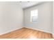 Hardwood floors and large window in a bright bedroom space at 200 Fairmont Dr, Spring Hill, FL 34609