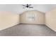 Large bonus room featuring neutral walls, plush carpet, and a ceiling fan at 200 Fairmont Dr, Spring Hill, FL 34609