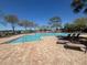 Large community pool with ample seating and lush landscaping at 200 Fairmont Dr, Spring Hill, FL 34609