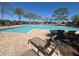 Community pool with ample seating and lush landscaping at 200 Fairmont Dr, Spring Hill, FL 34609
