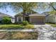 Charming home featuring a well-manicured lawn, two-car garage, and beautiful landscaping at 200 Fairmont Dr, Spring Hill, FL 34609