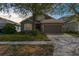 Charming home featuring a well-manicured lawn, two-car garage, and beautiful landscaping at 200 Fairmont Dr, Spring Hill, FL 34609
