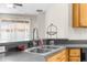 A stainless steel kitchen sink with a view to the exterior through vertical blinds at 200 Fairmont Dr, Spring Hill, FL 34609