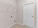 Laundry room includes tile floors, wire shelving, and convenient hookups at 200 Fairmont Dr, Spring Hill, FL 34609