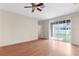 Hardwood floor living room with glass sliding doors to the backyard at 200 Fairmont Dr, Spring Hill, FL 34609