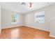 Open living space with hardwood floors, large windows, and neutral wall colors at 200 Fairmont Dr, Spring Hill, FL 34609