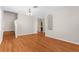 Bright living room with hardwood floors, staircase, and a glimpse into the adjacent kitchen at 200 Fairmont Dr, Spring Hill, FL 34609