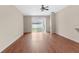 A large living room with hardwood floors leading to a glass sliding door to the exterior at 200 Fairmont Dr, Spring Hill, FL 34609