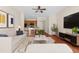 Staged living room with modern furniture and view of the kitchen at 200 Fairmont Dr, Spring Hill, FL 34609