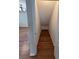 Angled storage space with hardwood floor in bonus room with chandelier in background at 200 Fairmont Dr, Spring Hill, FL 34609
